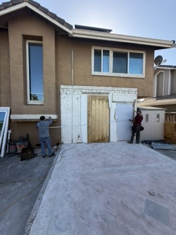 Rear elevation of the house with the addition opening framed and the existing slab in place