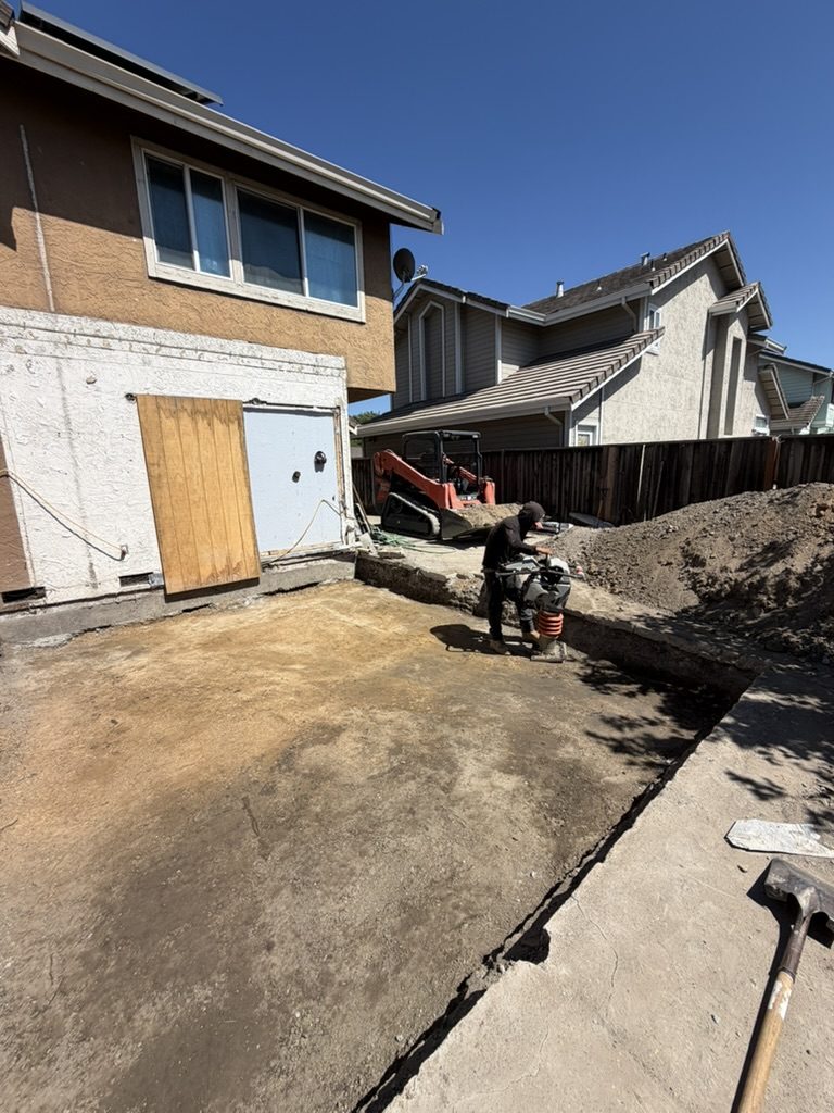 Over-excavation and compaction of the building pad after slab removal